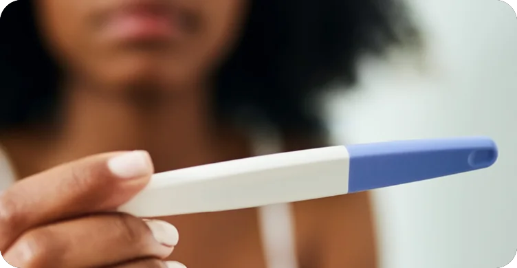 Woman Looking at Pregnancy Test